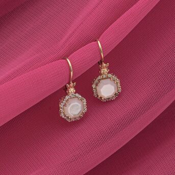 Framed by shimmering diamonds, VAHAN Jewelrys mother of pearl drop earrings enhance her look with a